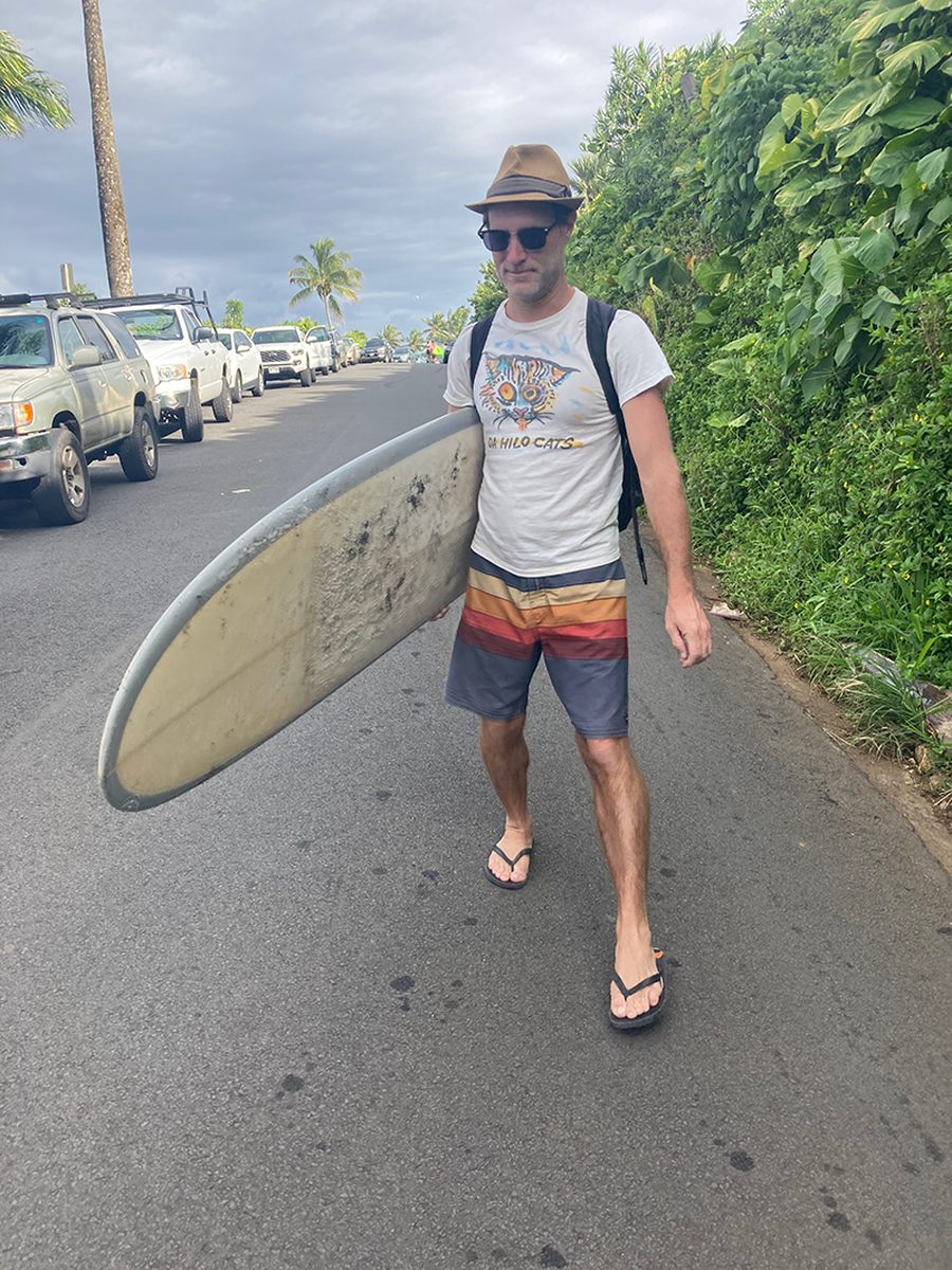 Chris in Hilo with surfboard